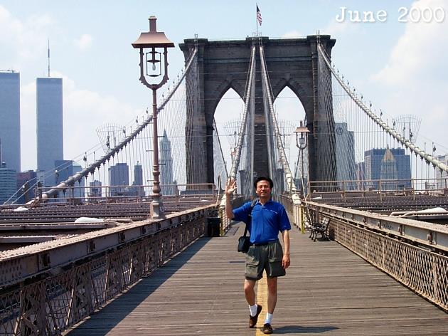 Sam C. Chan walking across the Brooklyn Bridge. June 2000.